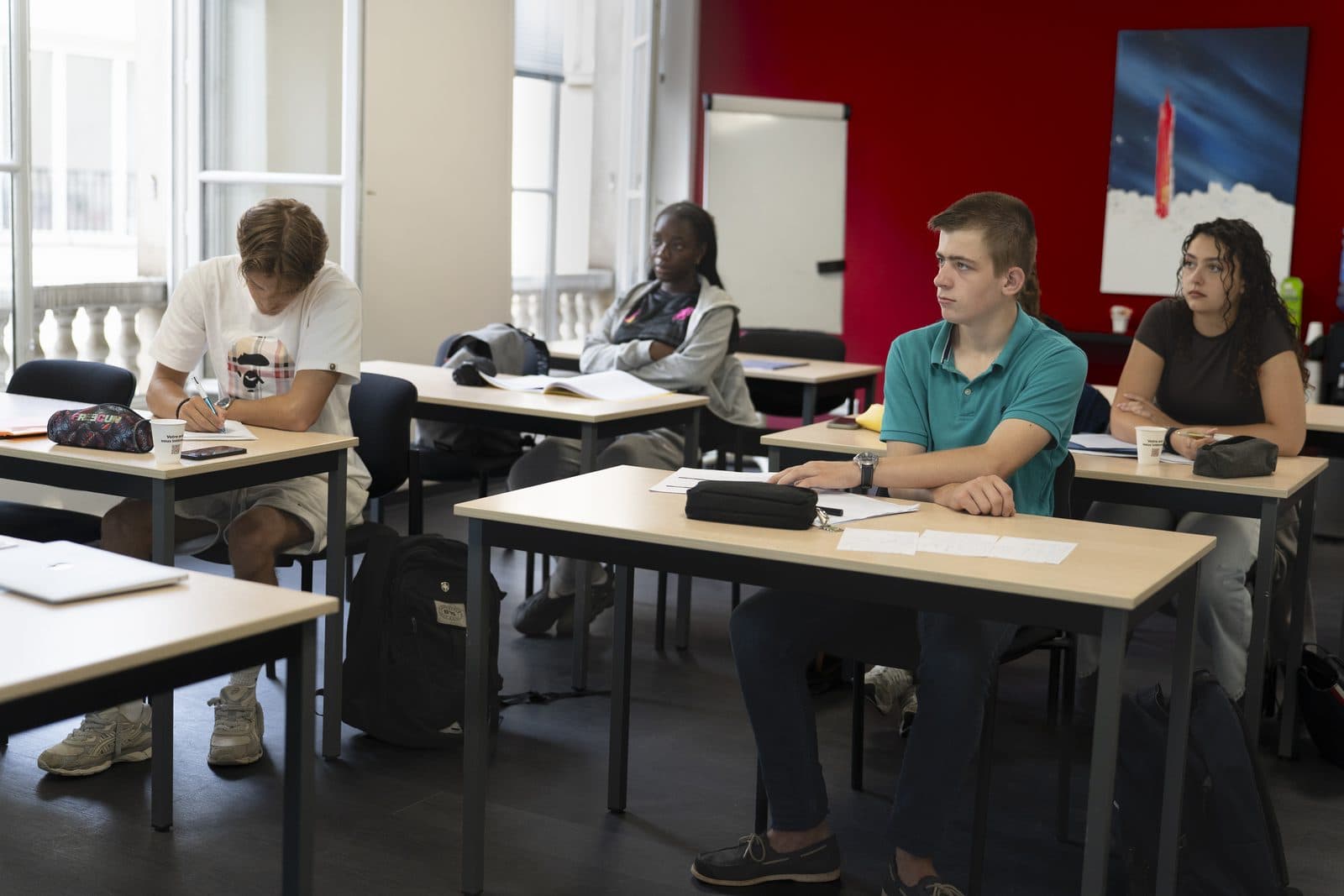 Des élèves travaillent à leurs tables dans la salle de cours Majorant, à Paris.